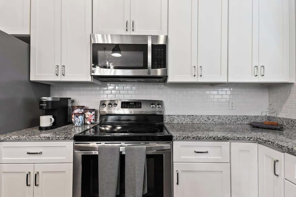 Quiet Corner - Minimal kitchen designs offer a calm contrast to the home's eccentric style. 