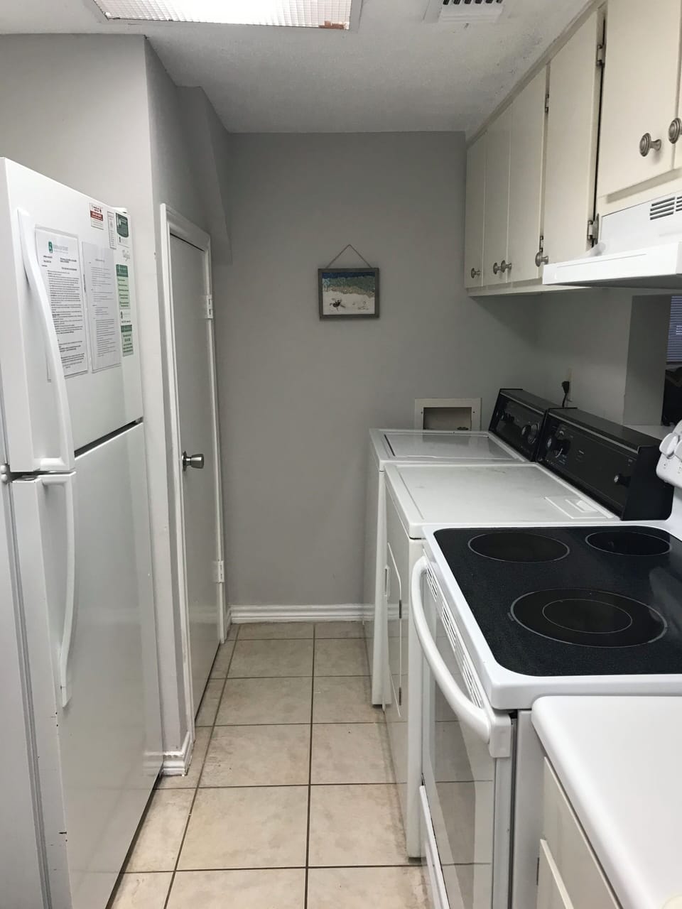 Kitchen with full size washer and dryer