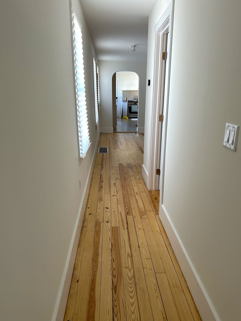 Hallway separates the Living room from the Kitchen.