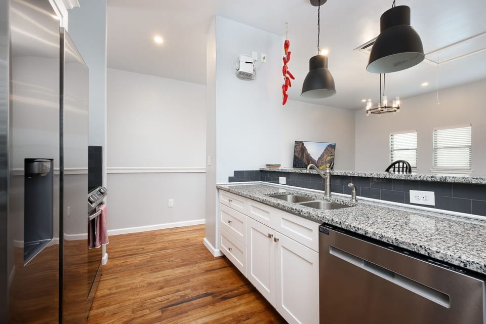 Clean and contemporary kitchen featuring sleek granite countertops