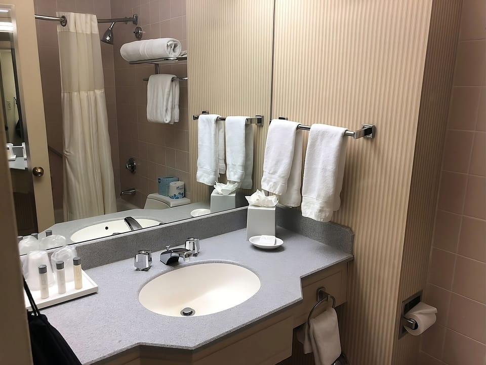 Refresh easily with a spotless vanity and fluffy towels.