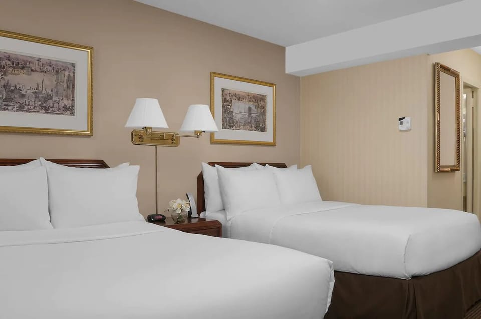 Drift off in plush beds beneath warm, inviting bedside lamps.