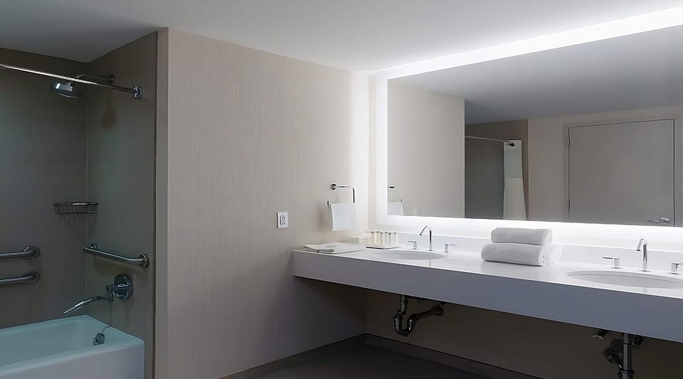 Bathroom with a shower and tub. The essential toiletries and towels are provided