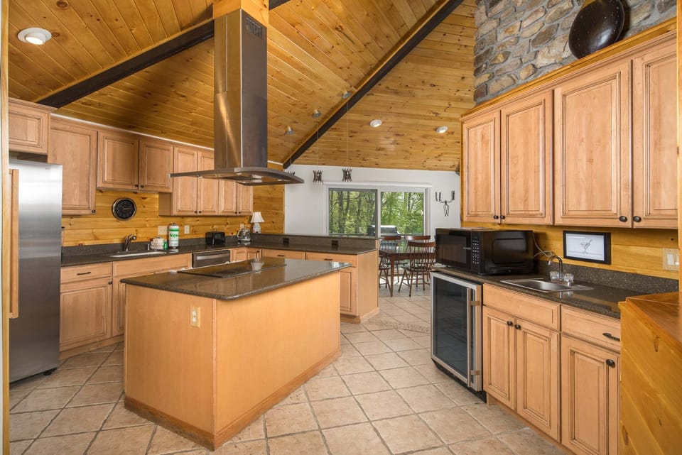Spacious kitchen with center island, modern appliances, and mountain cabin charm