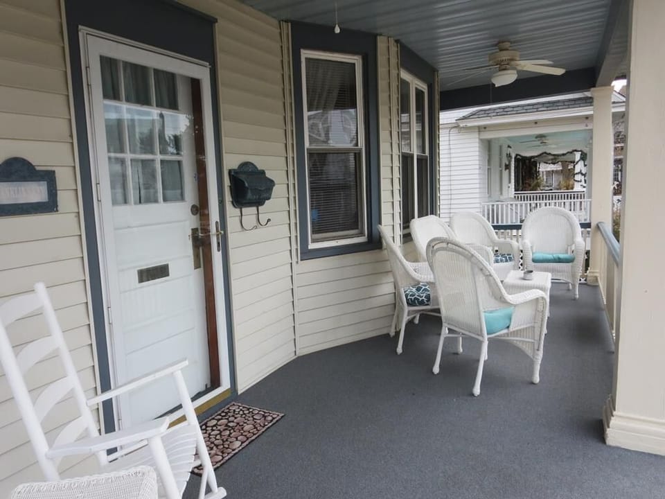 Relax on the cozy front porch, complete with wicker furniture and scenic views of Cape May’s horse-drawn carriages passing by.