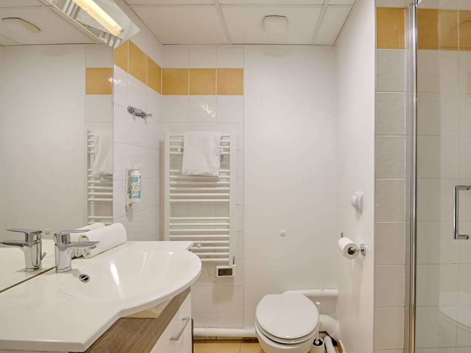 Contemporary bathroom with a sleek walk-in shower, heated towel rail, and bright, modern fixtures for a spa-like feel.