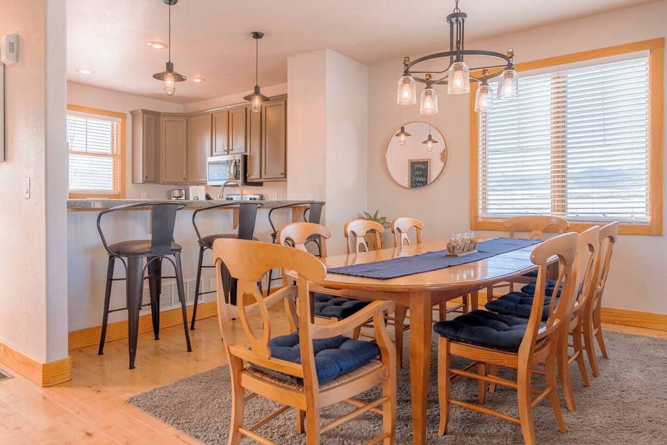 The dining area seats eight, with three more at the kitchen island—ideal for meals and gatherings.