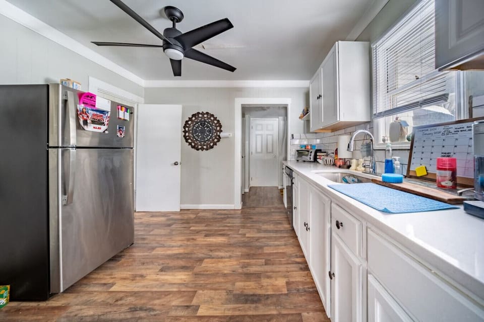 The kitchen is fully stocked, with stainless steel appliances and a gas stove