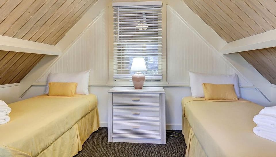 Recharge in cozy twin beds tucked under charming peaked ceilings.
