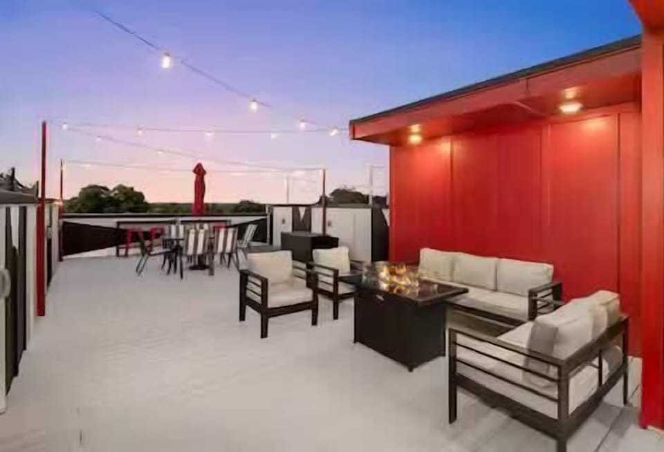 Rooftop lounge with firepit, games & skyline views.