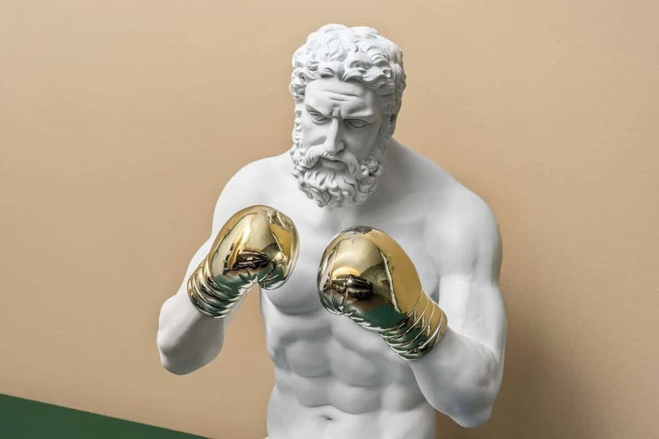 This bold bedroom decor features a knockout centerpiece—a Greco-Roman bust sporting shiny gold boxing gloves. A fun, stylish touch that sets the tone for a playful and unforgettable stay.