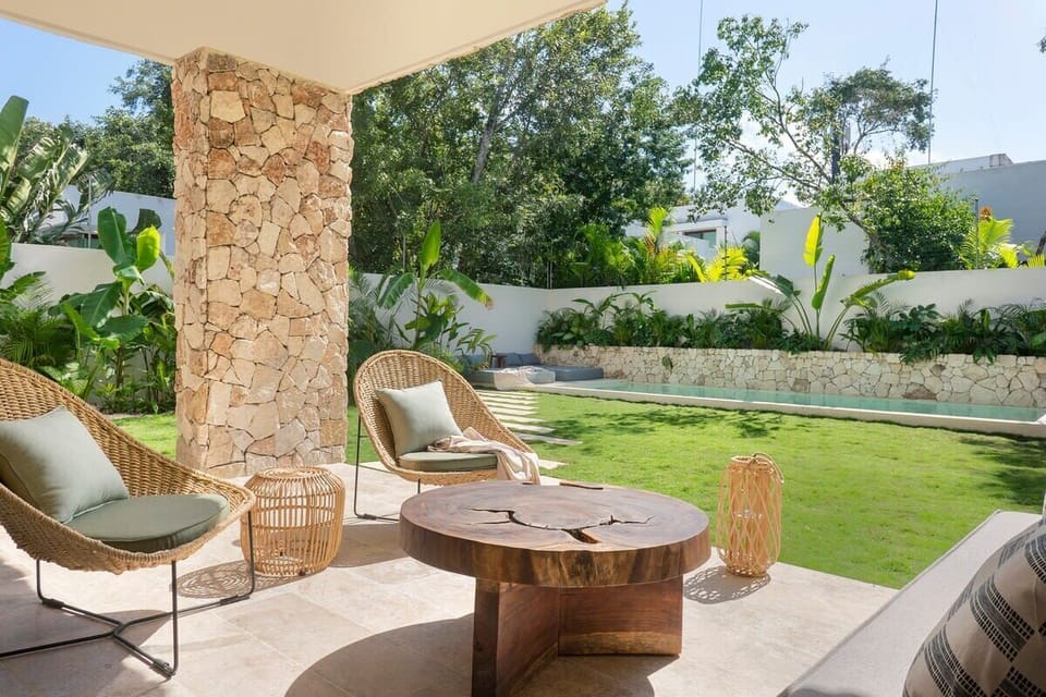 Elegant outdoor lounge set with a view of the garden and pool.