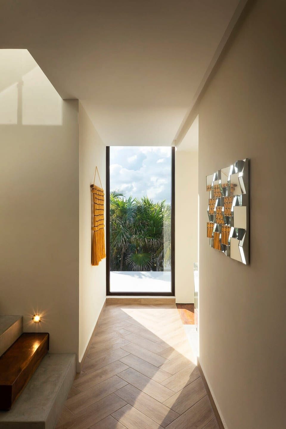 Modern hallway with a beautiful window that allows a view of the exterior landscape.