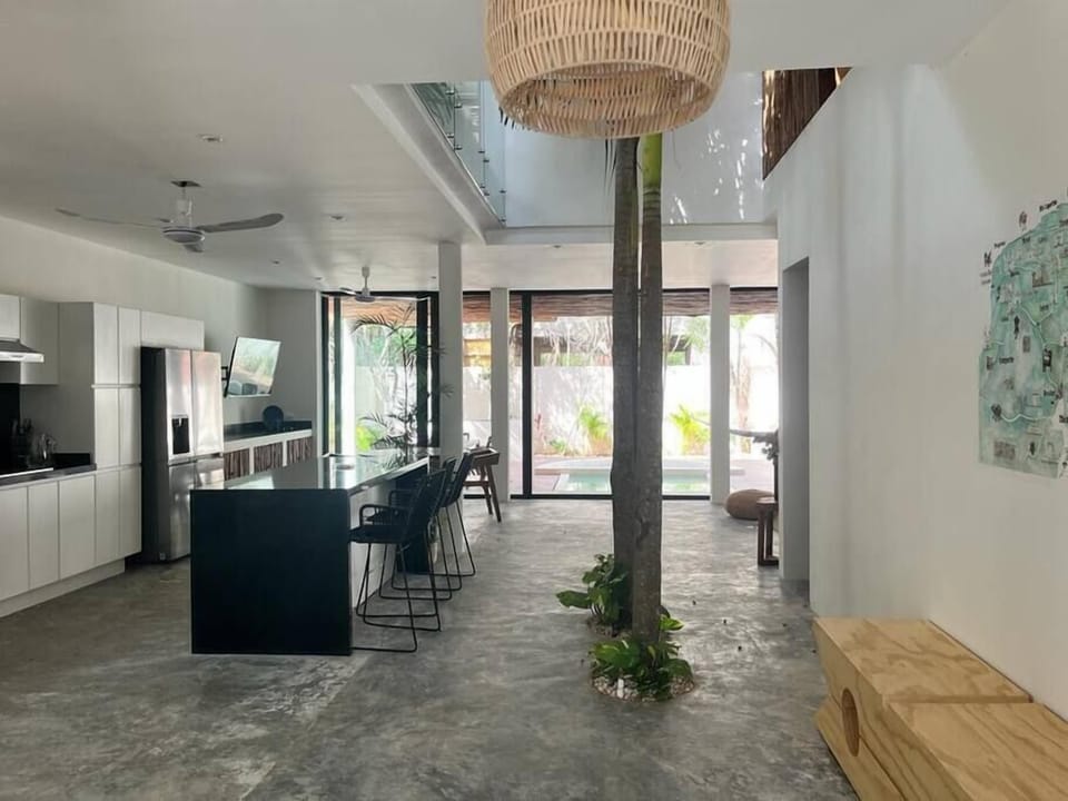 Fantastic fully-equipped kitchen with modern appliances. Natural trees in the center complete the space.
