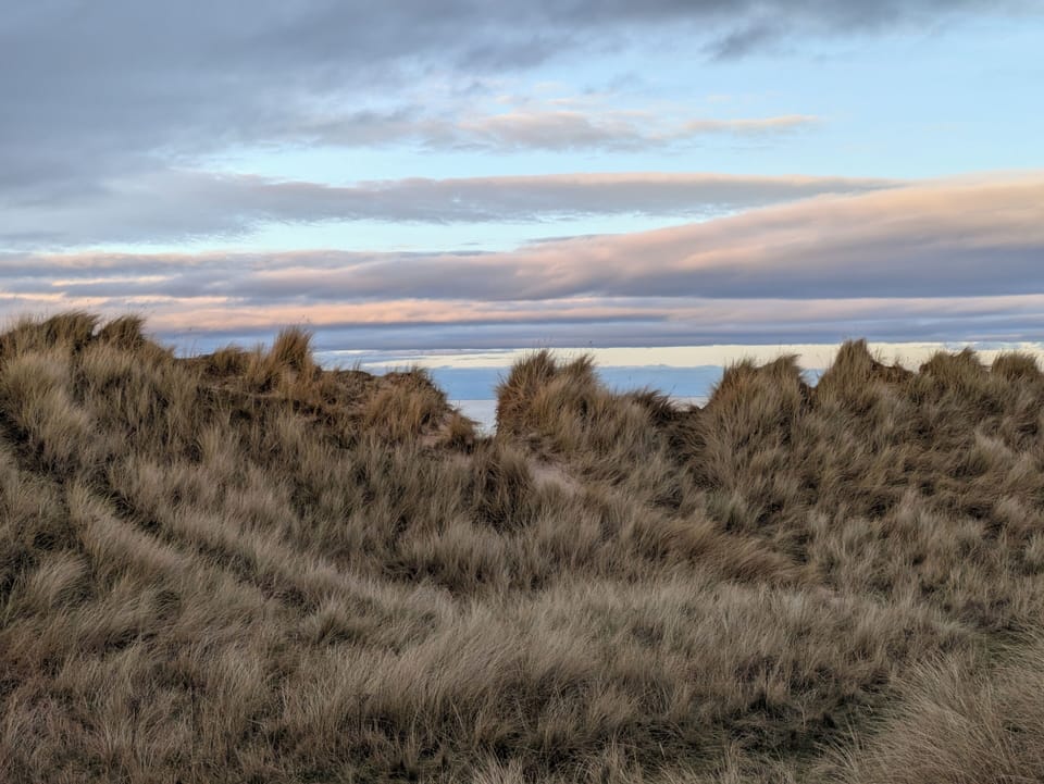 Over the Dunes there be the Sea, lapping at the Silvery Sands of the Beach