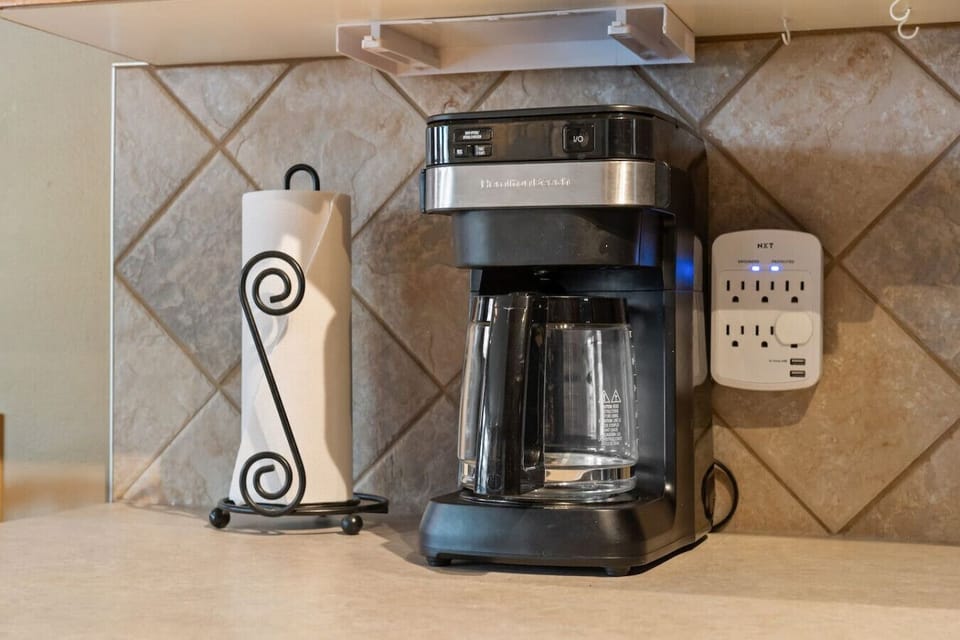 Full kitchen with a blender, crockpot/slow cooker & a drip coffee maker.