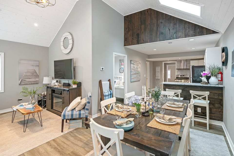 Table with seating for six along with breakfast bar area.