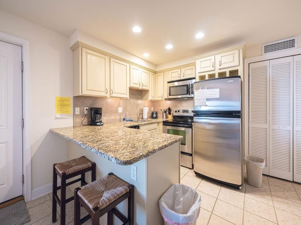 Granite breakfast bar with seating—perfect for a quick bite or sipping your morning coffee.