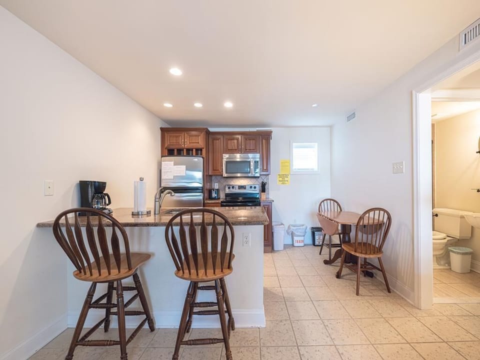 Open dining and kitchen area with seating for four, creating a warm and inviting space for meals.