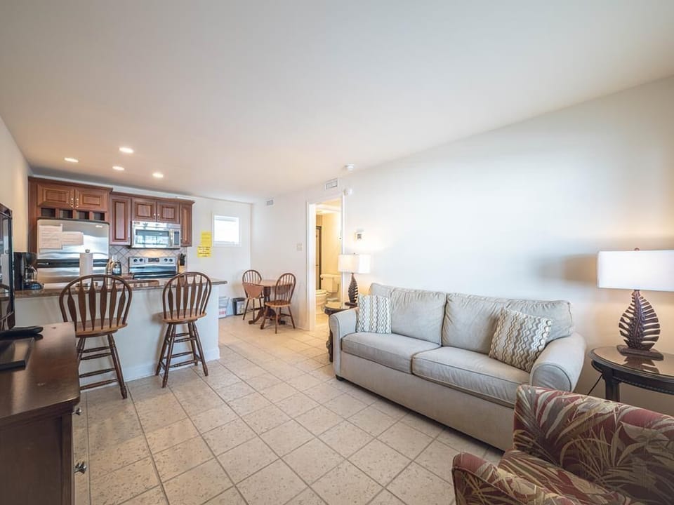 Bright and inviting living room with a queen sleeper sofa, perfect for unwinding after a beach day.
