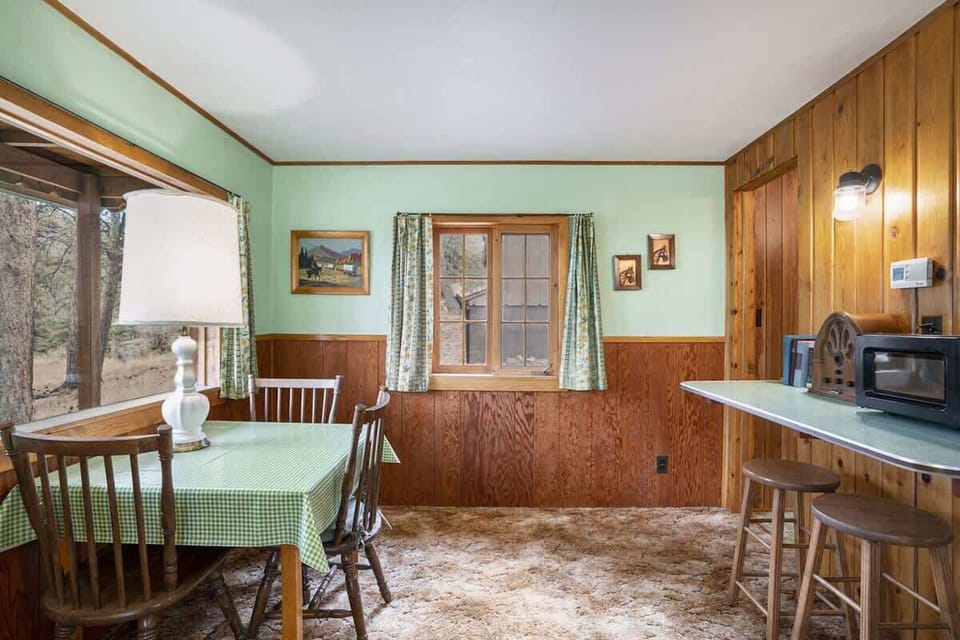 Dining room with table and extra bartop seating.
