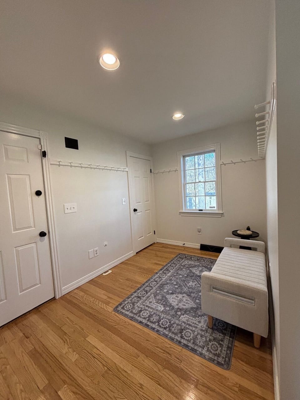 Entry foyer area for shoe and jacket storage away from gathering spaces