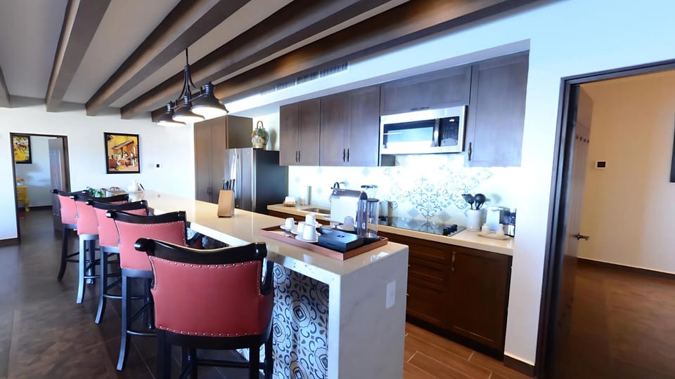 Vista Encantada gourmet kitchen island with bar seating and style.