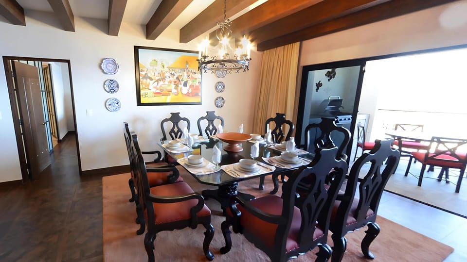 Vista Encantada elegant dining area with chandelier and balcony view

