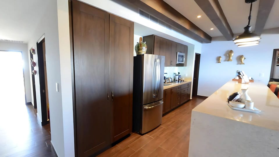 Vista Encantada modern kitchen with stainless appliances and storage.