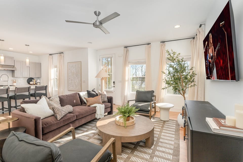 Relax in this stylish living room with comfortable seating, modern decor, and a flat-screen TV