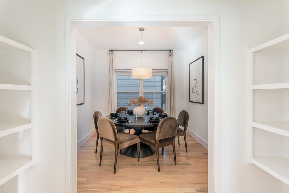 Enjoy meals together in this inviting dining area, offering a spacious table for family dinners or casual breakfasts.