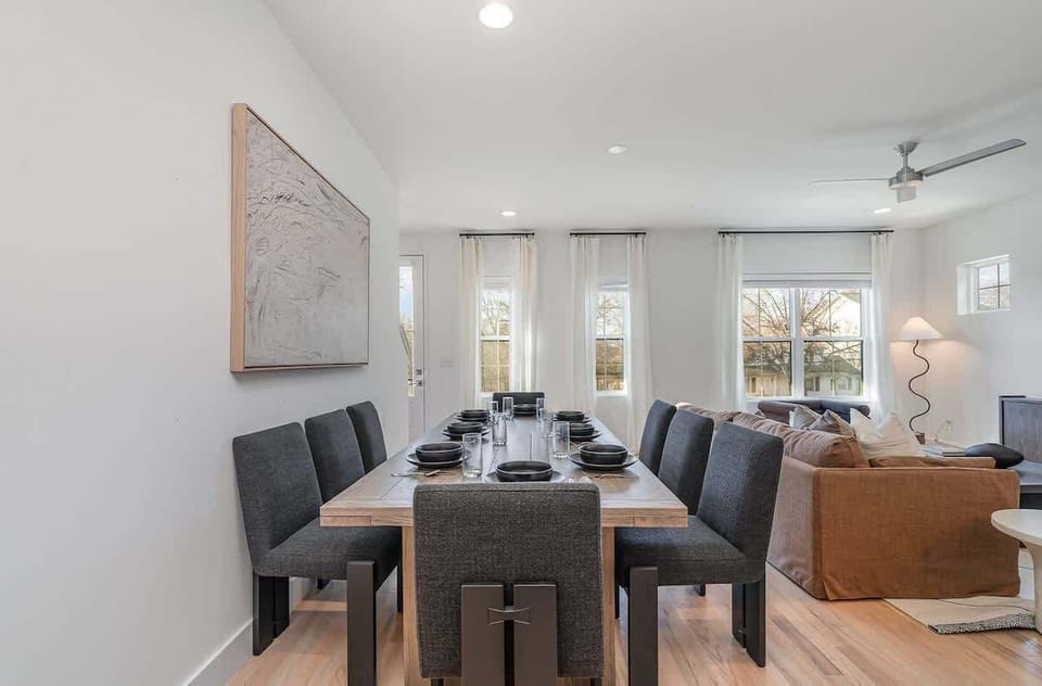 Gather around the spacious dining table for meals and conversation, creating lasting memories in this welcoming space.