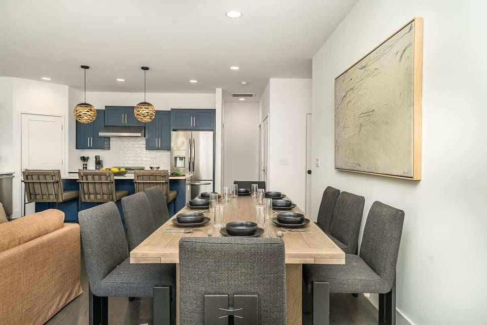 Gather around the spacious dining table for meals and conversation, creating lasting memories in this inviting space.