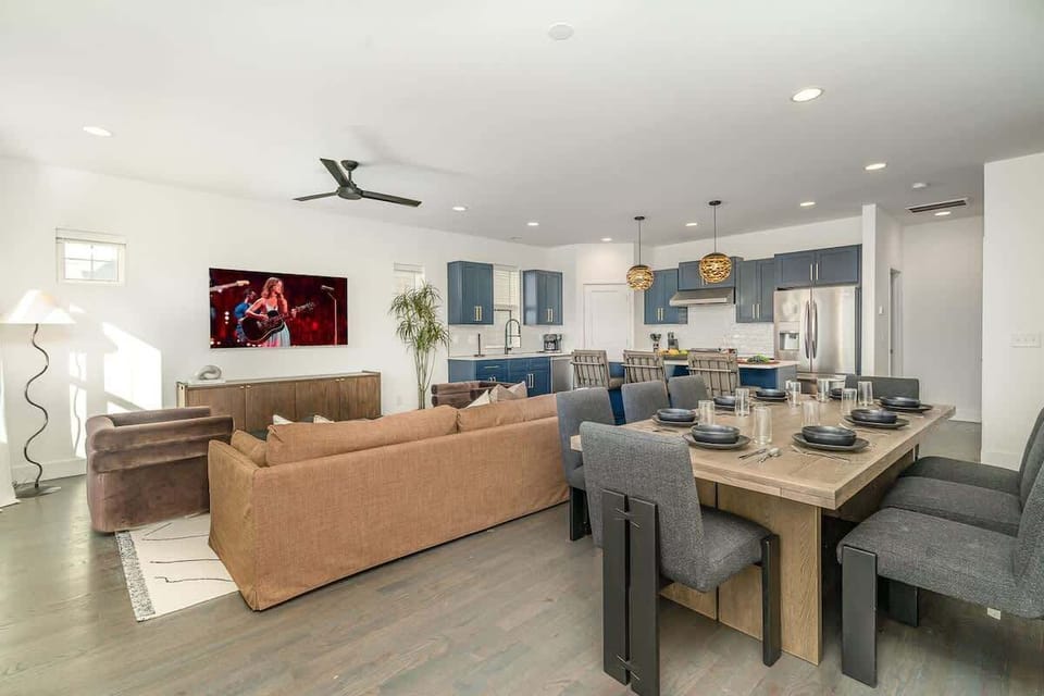 Relax in the cozy and stylish living room, complete with comfortable seating, a flat-screen TV, and large windows that bring in plenty of natural light.