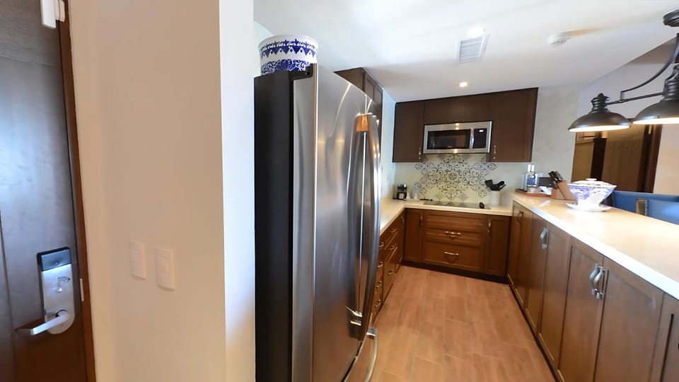 Fully stocked kitchen at Vista Encantada with bar seating and décor