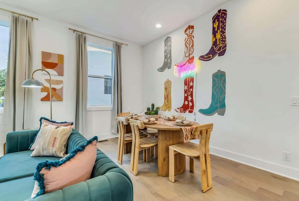 The dining room brings cowboy boot artwork and neon glow to family dinners and group meals, with seating for everyone to gather around one table