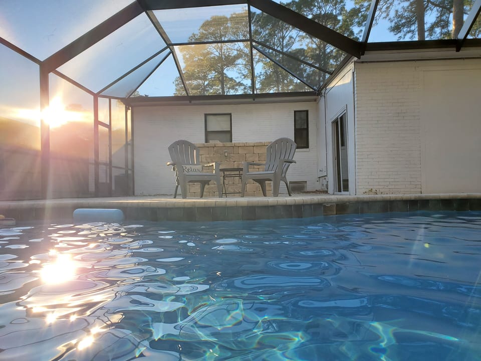 Enjoy the sparkling waters in the comfort of the screened pool deck. 