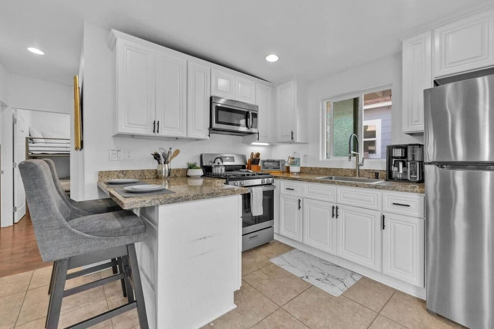 Fully stocked kitchen with blender, huge pots and coffee maker