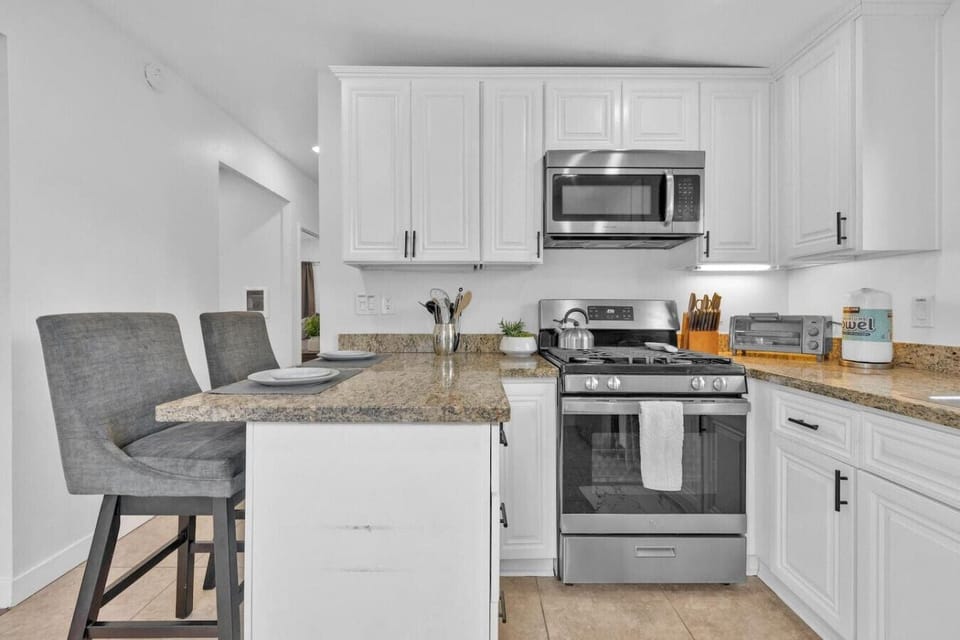 Fully stocked kitchen with blender, huge pots and coffee maker