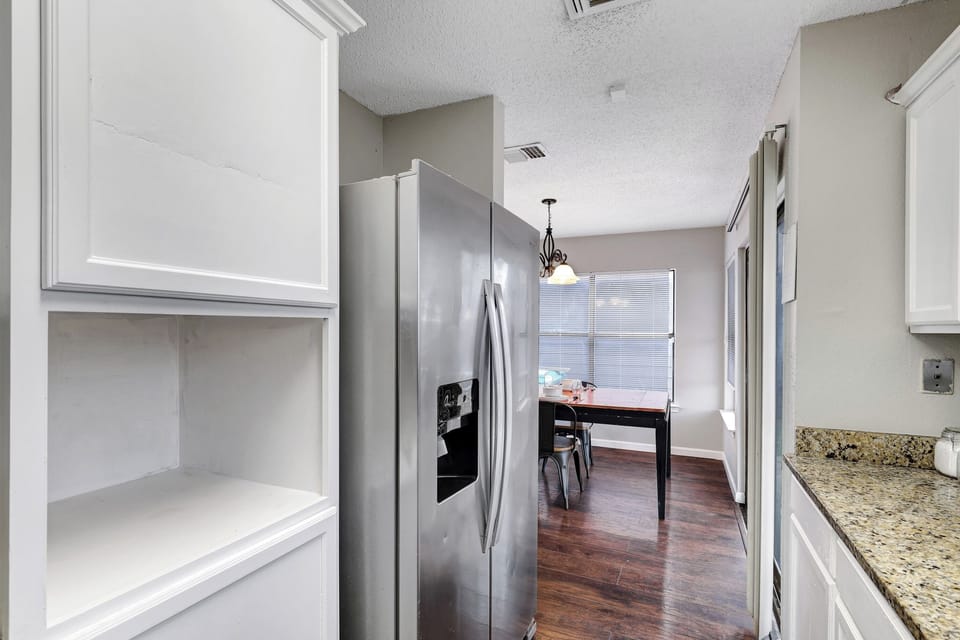 Fridge dispenses water and ice. Stainless steel appliances. 