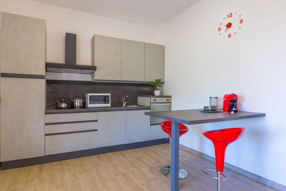 Furniture, Kitchen, Flooring, Countertop, Kitchen Appliance, Interior Design, Wood, Cabinetry, Floor, Major Appliance