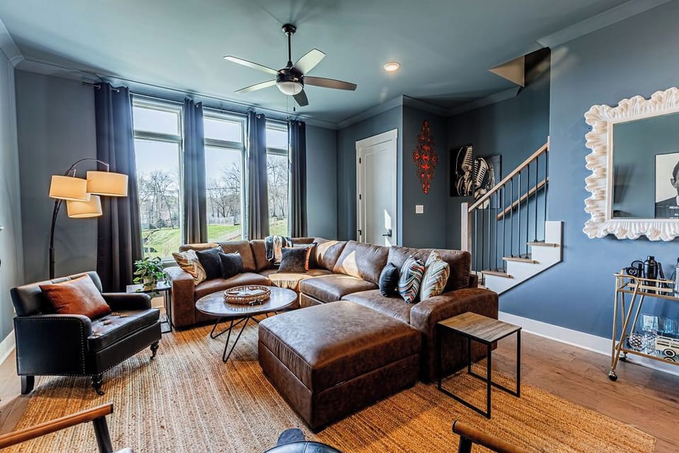 Open concept living area with stylish furnishings and TV