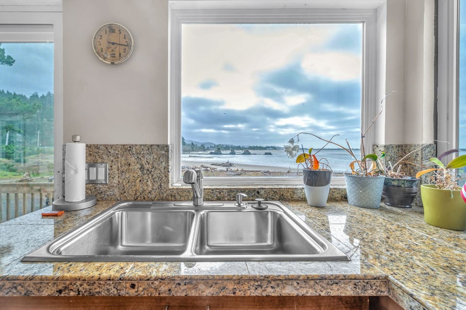 Your kitchen sink becomes a window to paradise with stunning sea views stretching to the horizon, making meal prep feel like a peaceful retreat.