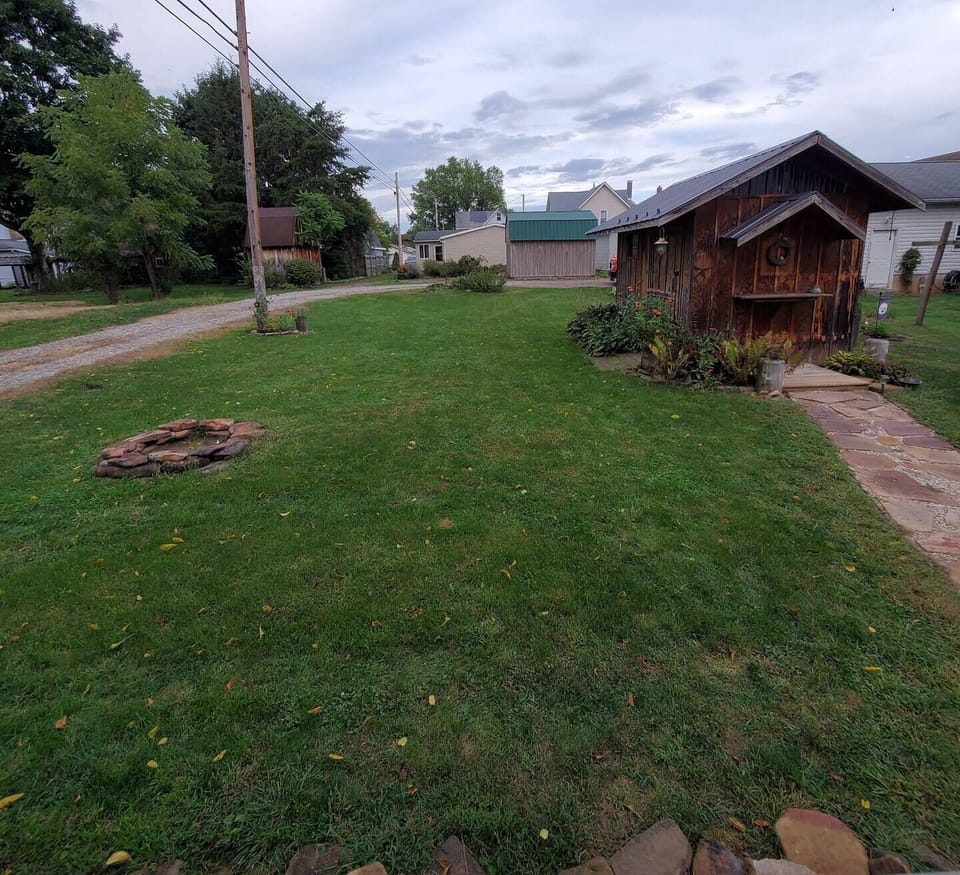 Backyard, shed with chairs, roasting sticks, and fire starters!