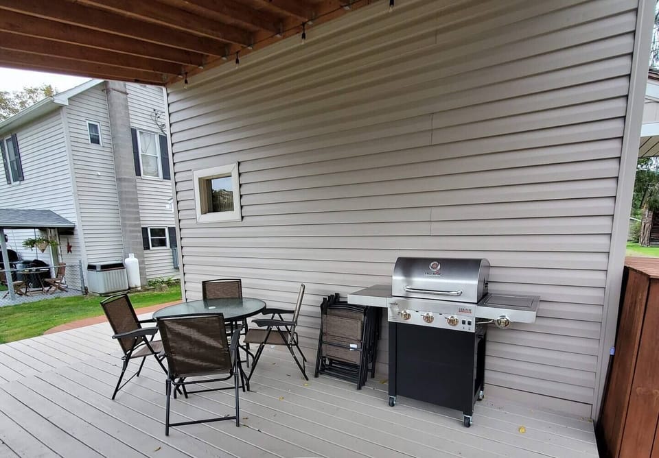 Back deck with dining chairs, table, and grill all ready to go! 