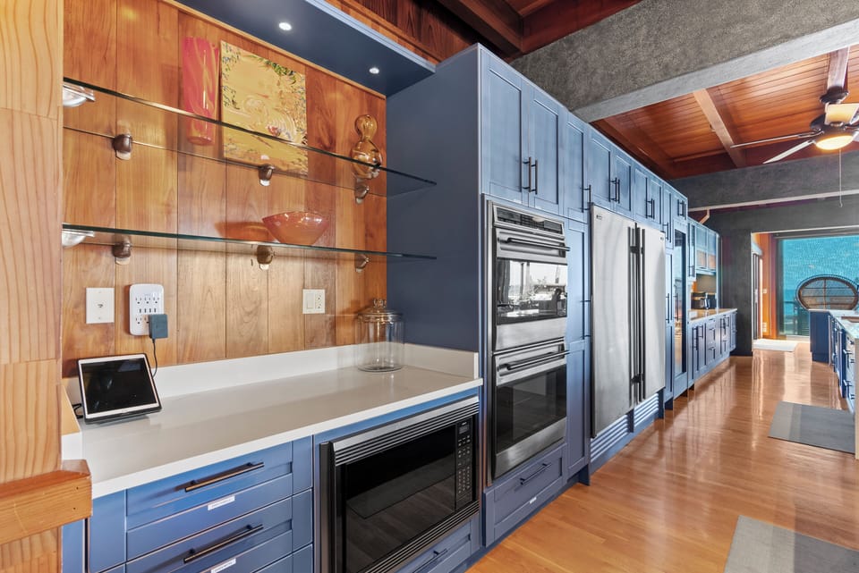 Designed for culinary enthusiasts, the gourmet kitchen offers double ovens, dual refrigerators, custom cabinetry, and abundant workspace for memorable meals.