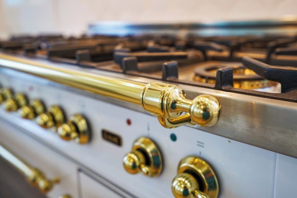Prepare culinary delights in this elegant kitchen featuring a professional-grade range, ample counter space, and a bright and airy design.
