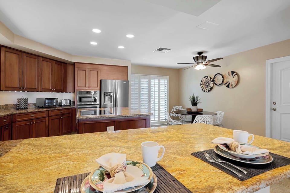 Seating for up to 12 guests between bar stools at the kitchen counter and two separate dining tables