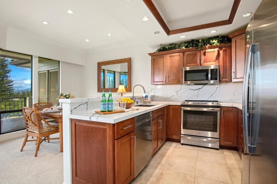 This kitchen pairs rich wood tones with crisp marble textures—perfect for morning brews and sunset sips alike   