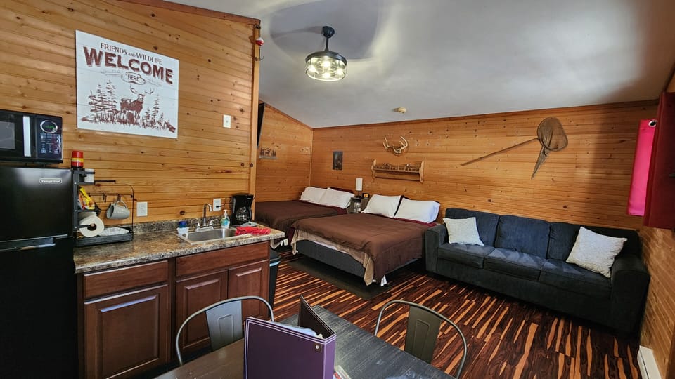 Living space (2 queen beds, sofa, kitchenette with dining set).